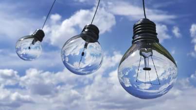 Light-bulbs-suspended-in-the-puffy-white-clouds-and-blue-sky
